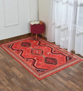 Machine washable tribal-style rug in rich red tones.